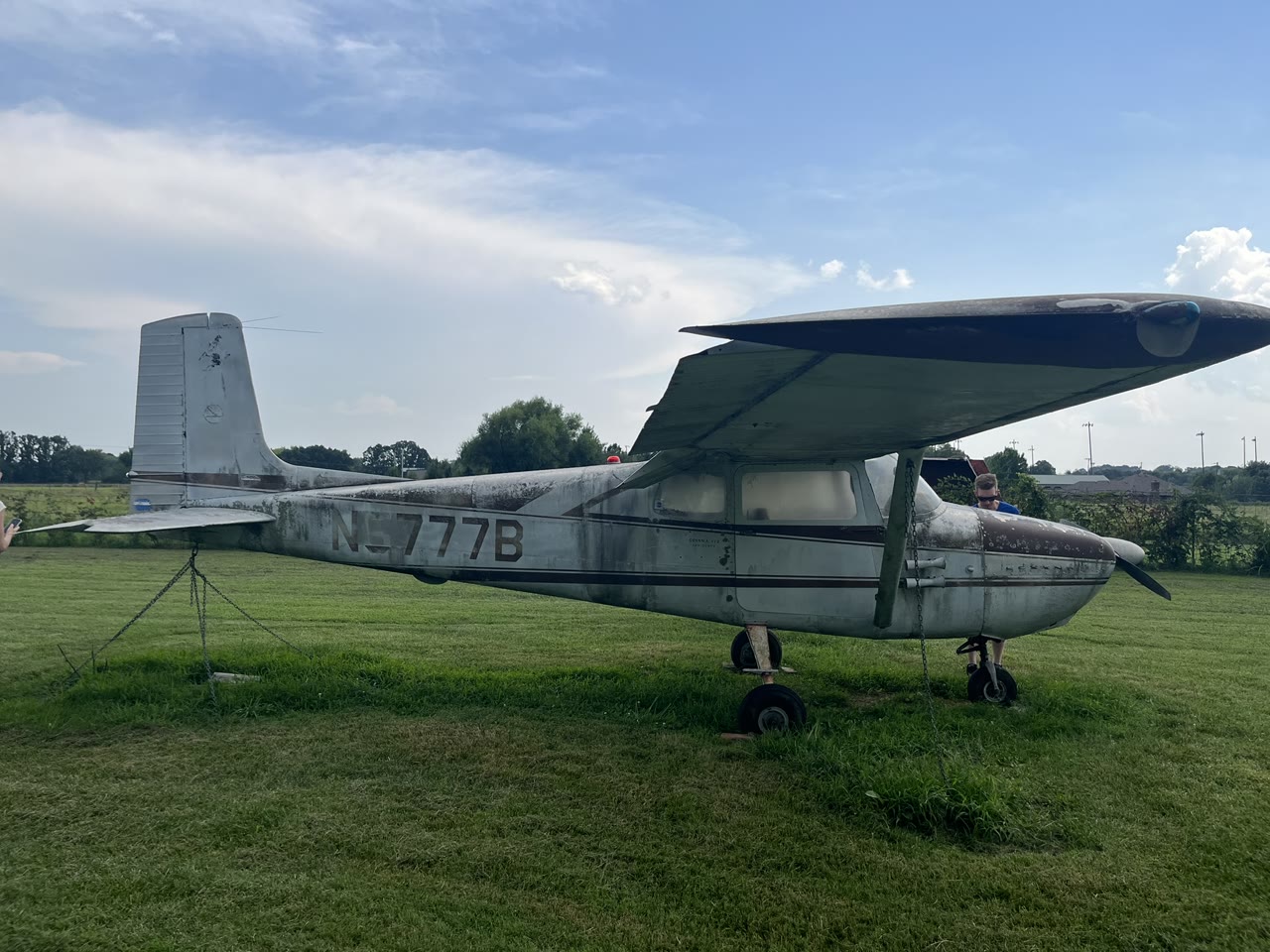 Left-side view of the complete N8777B airframe showing its faded finish and registration.