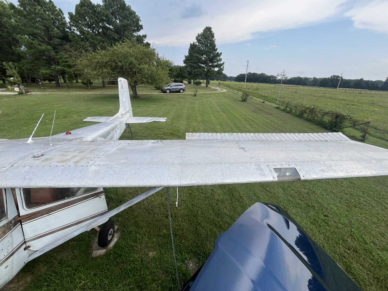 View across the upper wing and tail of N8777B documenting surface condition before restoration.