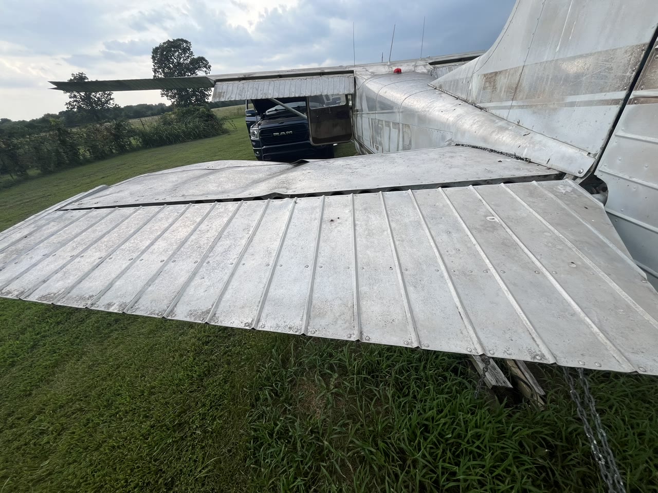 Close view of N8777B tail surfaces and weathered exterior during the initial condition survey.