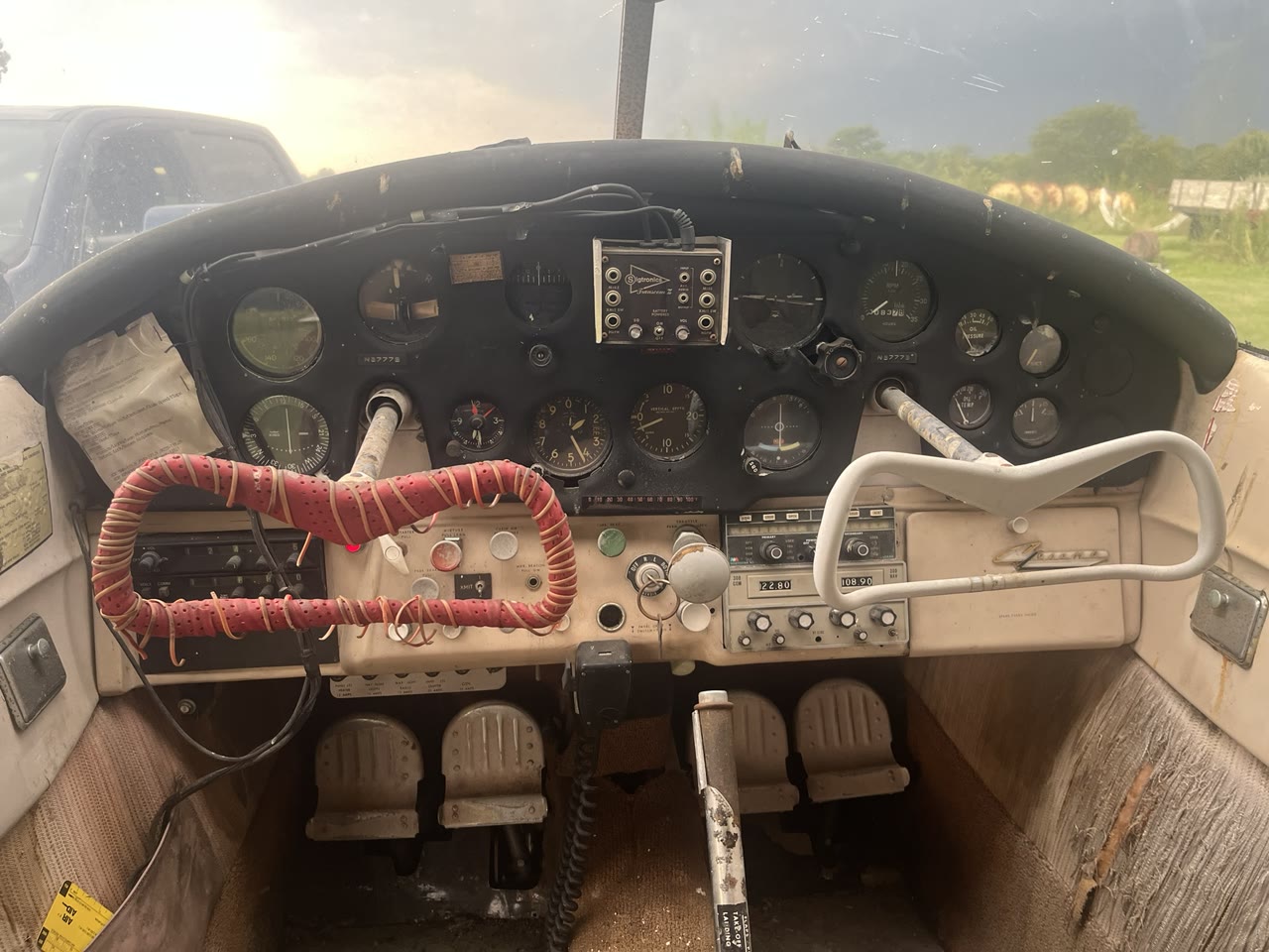 Original instrument panel and control yokes inside N8777B as acquired.