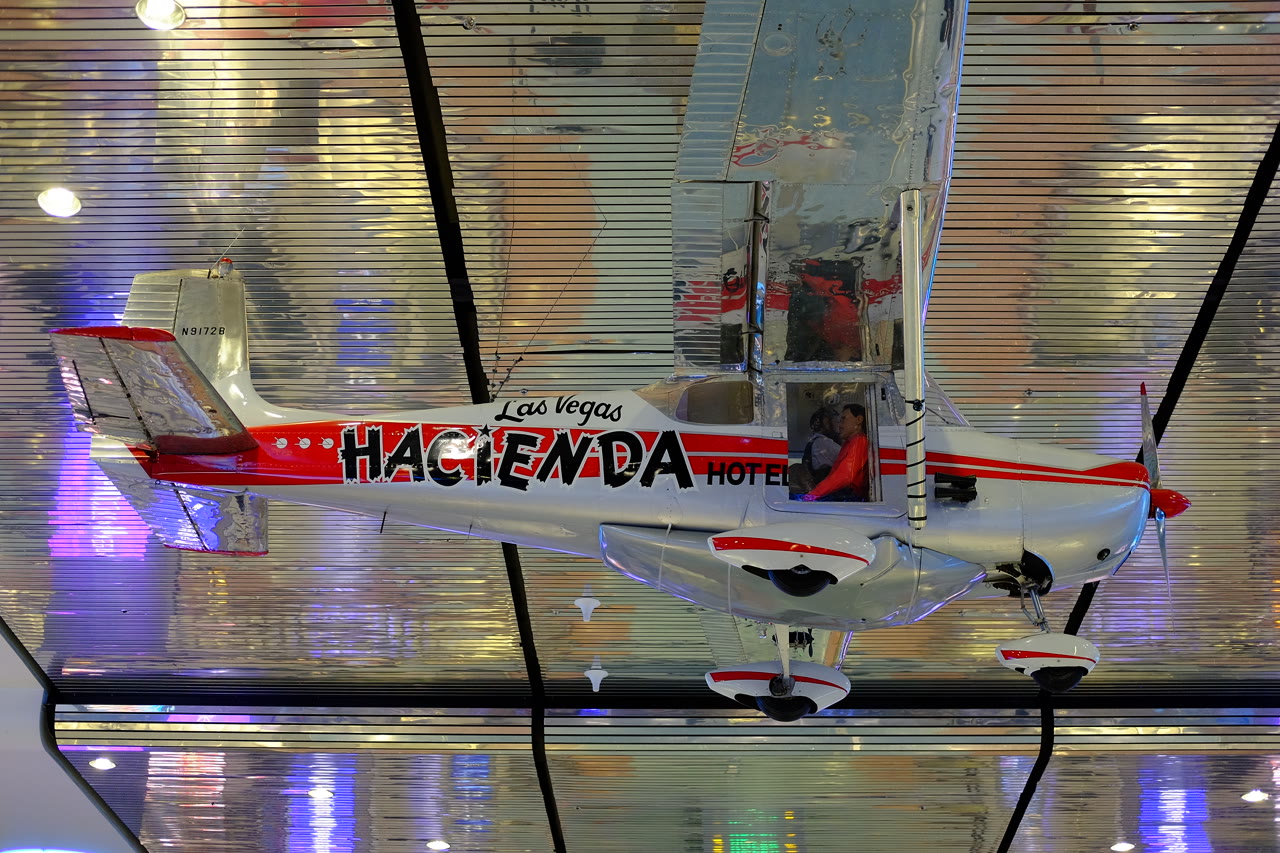 The silver and red Cessna 172 N9172B, Hacienda, suspended on public display inside the Las Vegas airport terminal.