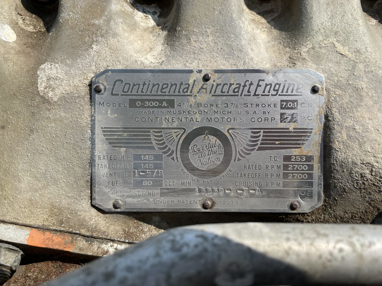 Close view of the original Continental O-300-A engine data plate installed on N8777B, including stamped model and serial information.