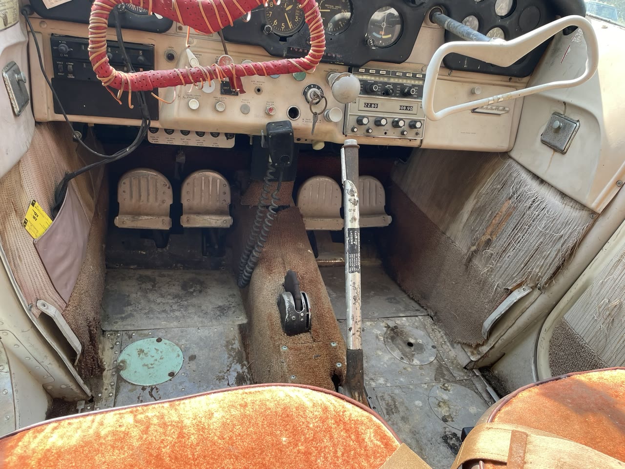 Close view of the cleaned cockpit floor, rudder pedals, control cables, and center-control area inside N8777B.