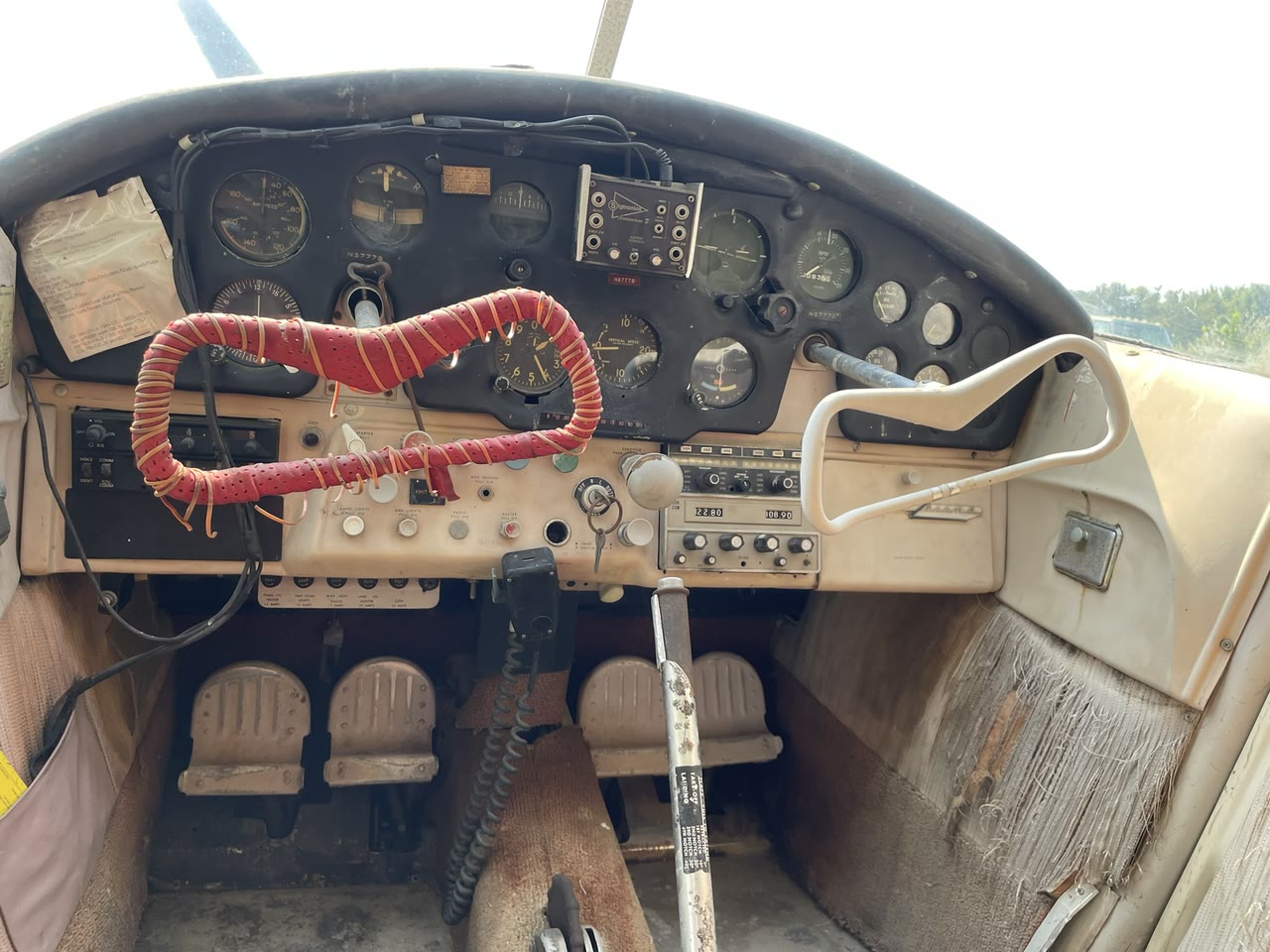 Forward cabin view of the original instrument panel and control yokes following initial professional interior cleaning.
